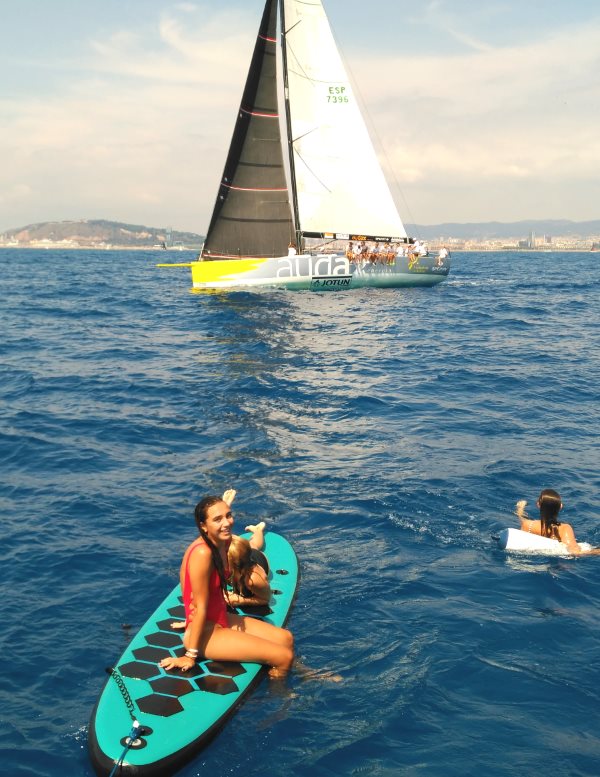 Girls enjoying a great experience at sea in front of Barcelona